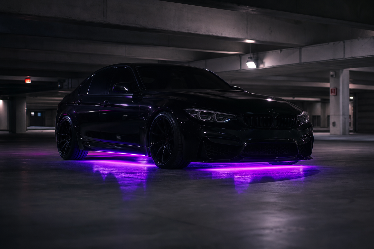 Blacked-out car with purple underglow